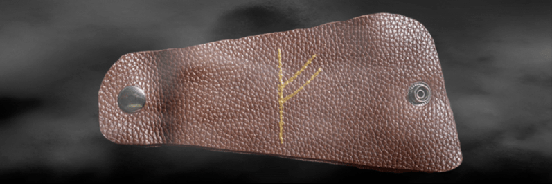 Fehu rune on the skin as a good luck charm.