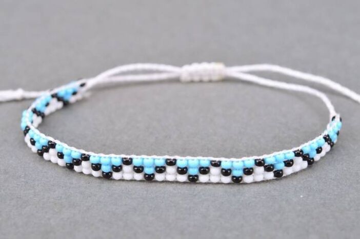 A bracelet made of threads and beads is a talisman that will bring good luck to its owner. 